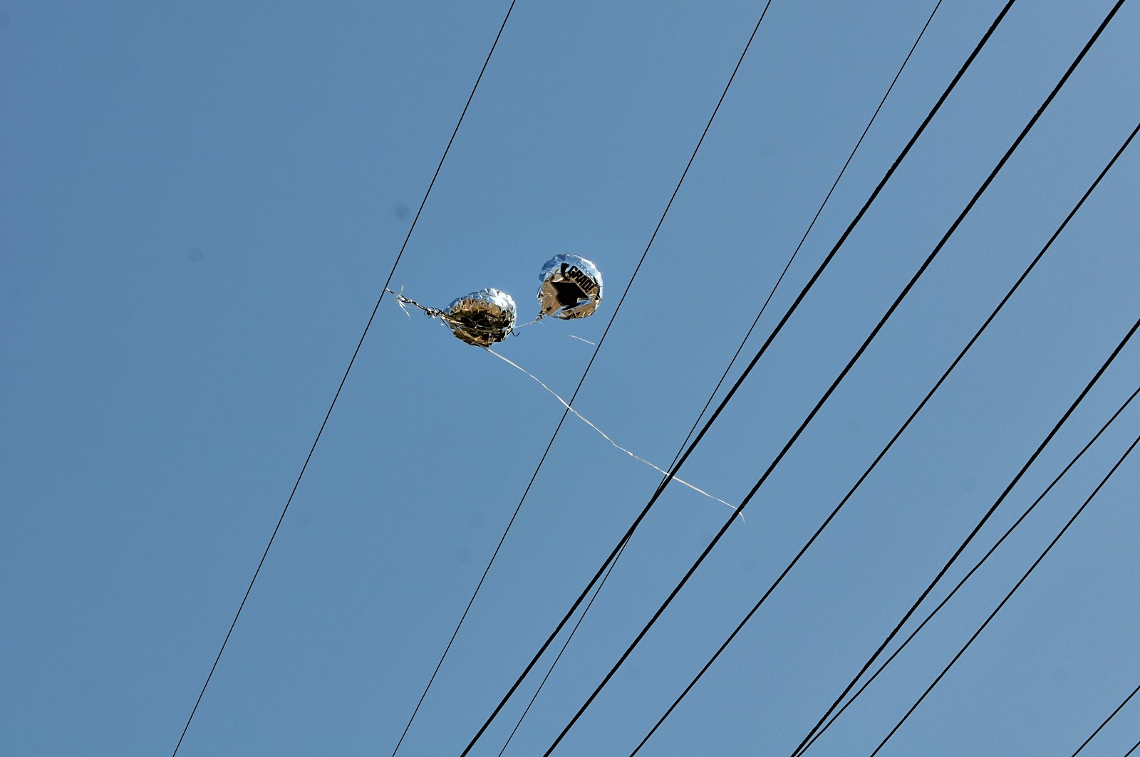 Balloons caught on power lines | Credit: D Coetzee on Flickr | License: CC0