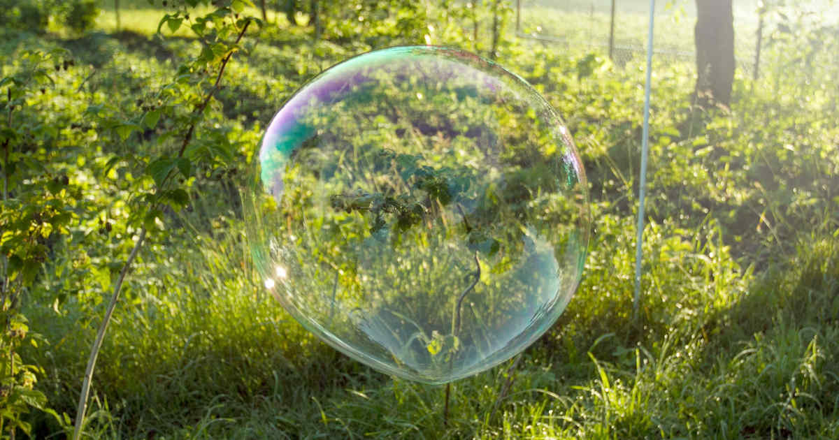 a bubble floating in the air in a field | Credit: Kostiantyn Li (@leekos) | License: CC0