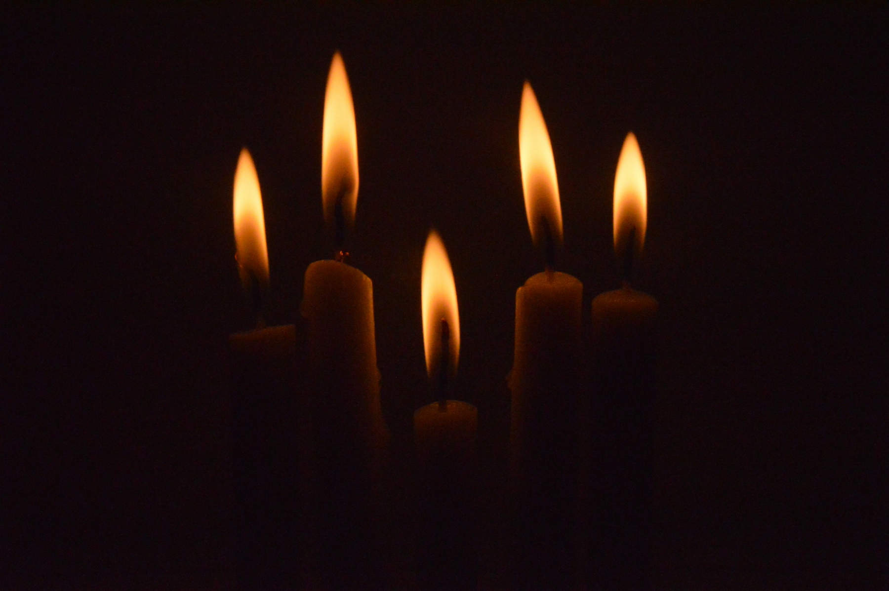 A group of lit candles in the dark | Credit: Inna Safa (@innasafa) | License: CC0