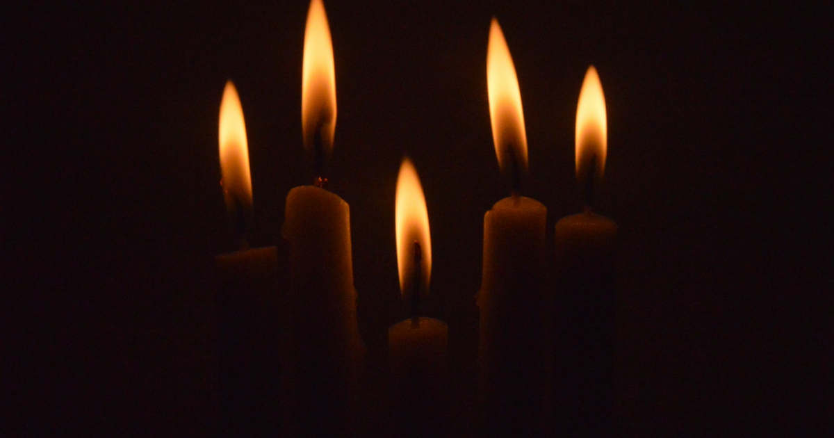 A group of lit candles in the dark | Credit: Inna Safa (@innasafa) | License: CC0